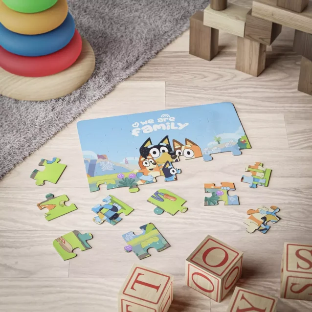 The durable metal tin for the custom Bluey family puzzle, featuring vibrant character art.