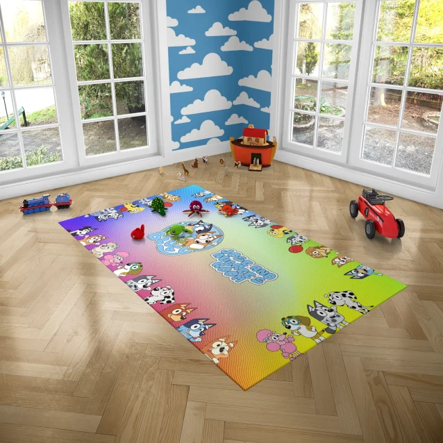 A happy child playing with toys on the Bluey and Bingo floor mat.