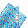 Kids' birthday present wrapped in vibrant Baby Shark wrapping paper.