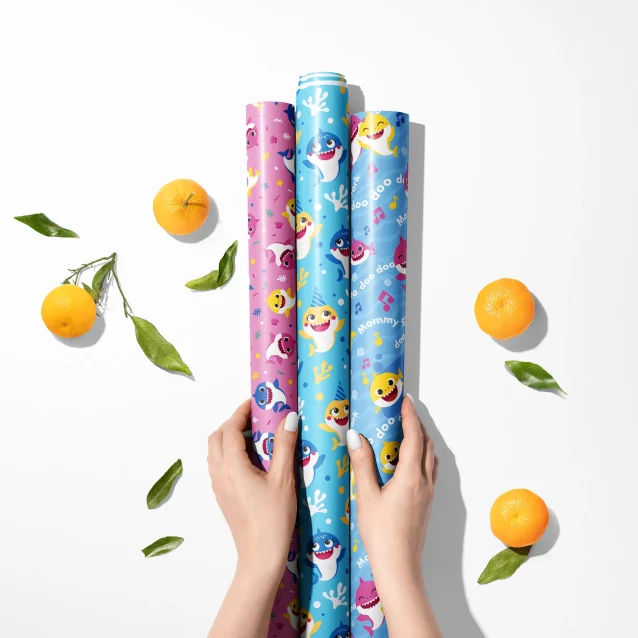 Action scene print on Baby Shark gift wrap with underwater elements.