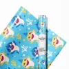 Close-up of the glossy finish on Baby Shark birthday wrapping paper.