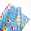 Roll of colorful Baby Shark wrapping paper featuring the whole Shark family.