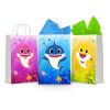 Three printable Baby Shark goodie bag fronts on paper party bags — underwater reef scenes with the pink, blue and yellow sharks swimming among coral and starfish.