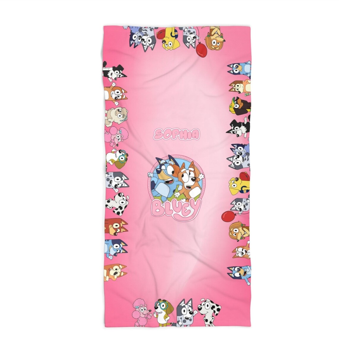 A close-up of the pink Bluey and Bingo beach towel, showing the sisters on soft quick-dry polyester terry.