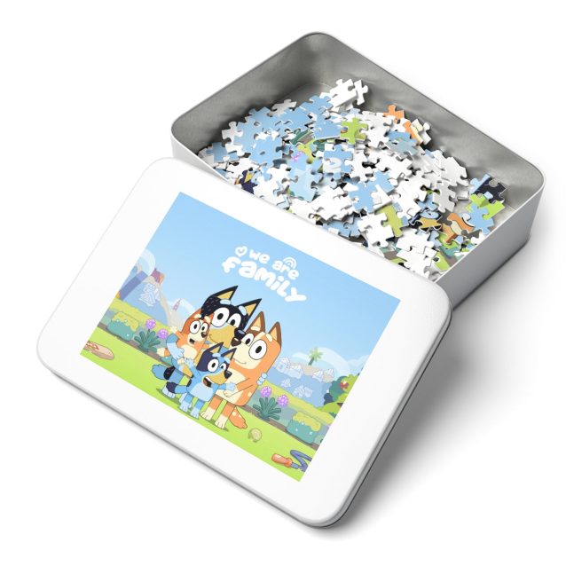 A child's hands carefully placing the last piece into a completed 110-piece Bluey puzzle for kids.