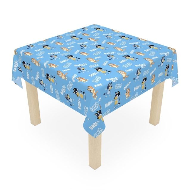 Bluey and Bingo dancing on a personalized blue polyester birthday tablecloth.
