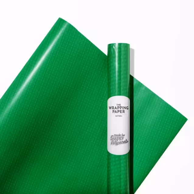 A brightly wrapped gift using Lego wrapping paper with a bow.