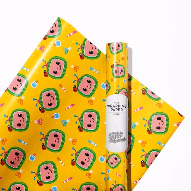 "Child happily unwrapping a gift wrapped in Cocomelon paper."