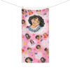 Spread out flat, the Encanto beach towel featuring Mirabel and the Madrigals, personalized with the printed name.