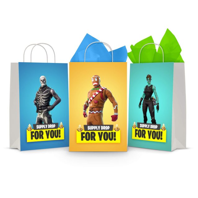 Three printable Fortnite goodie bag fronts on paper party bags — Skull Trooper on blue, the gingerbread skin on gold and Elite Agent on teal, each with a "Supply Drop — For You!" banner.