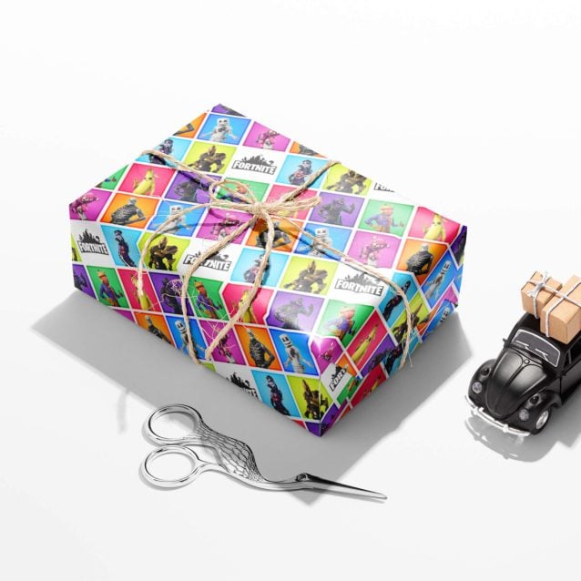 Fortnite birthday paper showcasing the Battle Bus and popular locations.