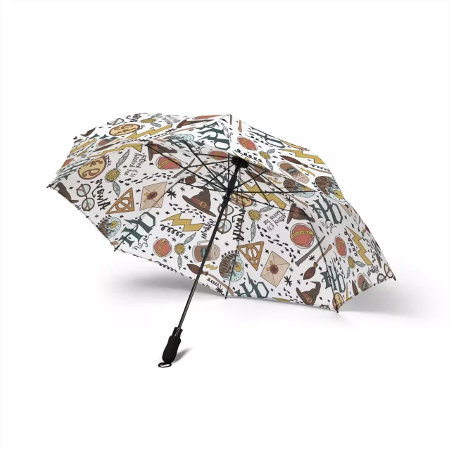 Black Harry Potter umbrella with gold Hogwarts crest fully open.