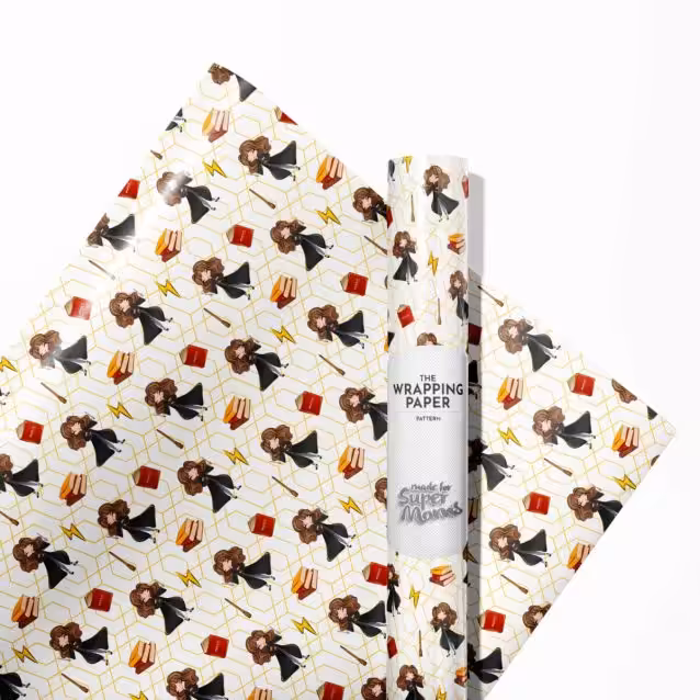 Unrolled sheet of Harry Potter wrapping paper displaying a magical Hogwarts castle scene.