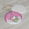 Angel Kitty in a green fairy dress over a pink winter sky - personalized Hello Kitty Christmas ornament with name and year