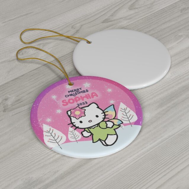 Angel Kitty in a green fairy dress over a pink winter sky - personalized Hello Kitty Christmas ornament with name and year