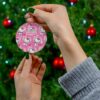 Repeating pink Hello Kitty pattern on a round personalized Christmas ornament for kids