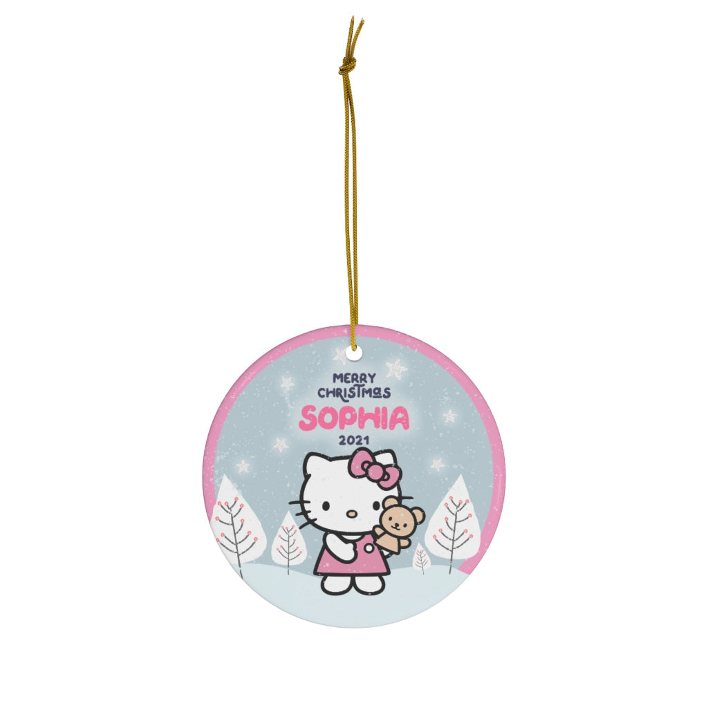Hello Kitty in a red dress holding her teddy in a blue winter village - custom name Christmas ornament