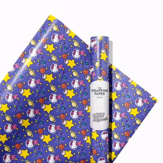 Child's hands wrapping a gift with easy-to-use Hello Kitty wrapping paper roll.
