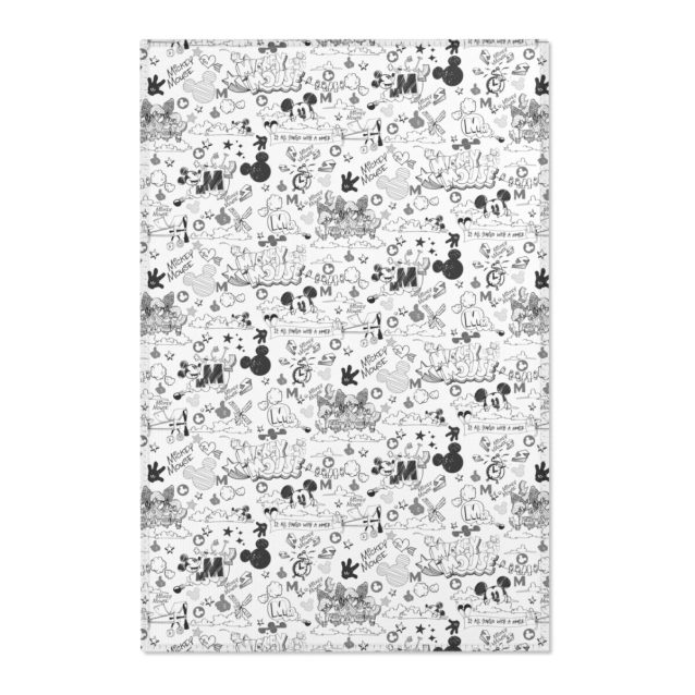 A Mickey Mouse rug in a brightly lit playroom.