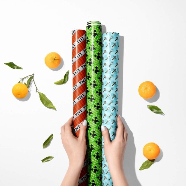 Detail of the 90 GSM gloss finish on Minecraft wrapping paper with a pixelated animal mob design.