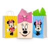 Three printable Minnie Mouse goodie bag fronts on paper party bags — Minnie waving in her red polka-dot dress on yellow, a big close-up of her face with the pink bow, and Minnie with her hands on her cheeks on blue.
