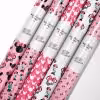 Roll of official Minnie Mouse wrapping paper featuring classic polka dot design.