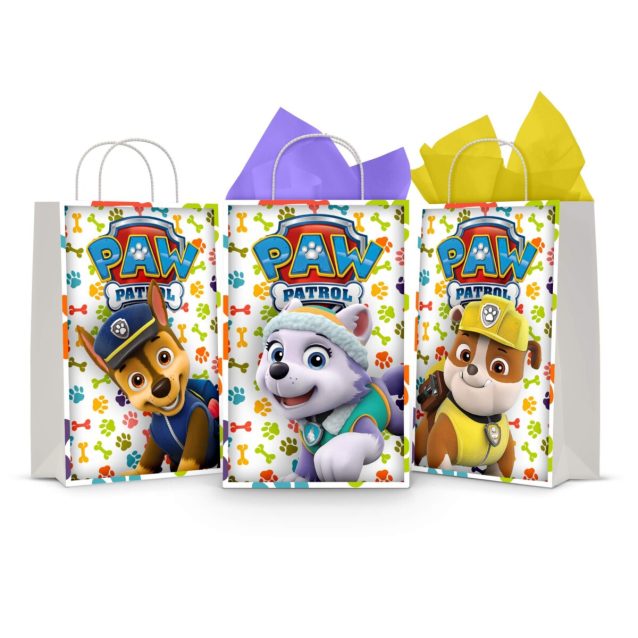 Three printable Paw Patrol goodie bag fronts on paper party bags — Chase the police pup, Everest the snow pup and Rubble the construction pup, each under the PAW PATROL badge on a paw-print background.