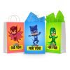 Three printable PJ Masks goodie bag fronts on paper party bags — Owlette on red, Catboy on blue and Gekko on green, each with the "For You!" banner.