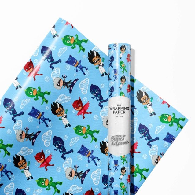 Child happily unwrapping a gift covered in PJ Masks wrapping paper.