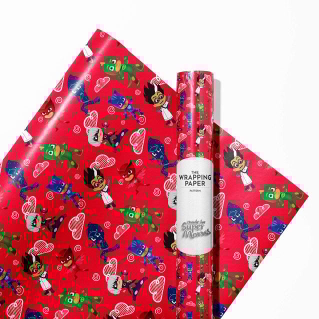 PJ Masks wrapping paper roll alongside a birthday cake and party decorations.