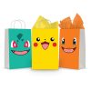 Three printable Pokemon goodie bag fronts on paper party bags — the big face designs for Bulbasaur on teal, Pikachu on yellow and Charmander on orange.