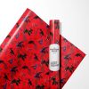 The 30x36 inch roll of Spiderman wrapping paper being used to wrap a small, handheld gift.