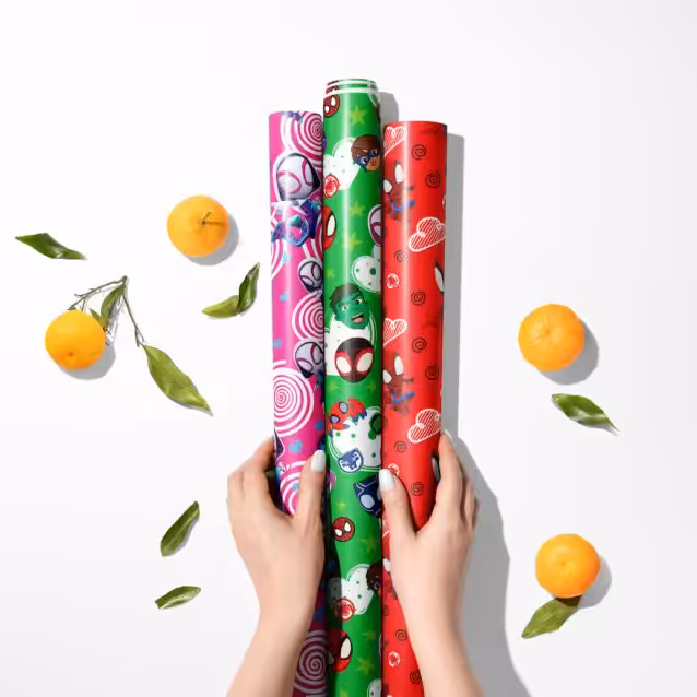 Close-up of a brightly colored Spidey and His Amazing Friends gift wrap pattern.