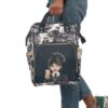 Wednesday Addams diaper bag held by the top handles, chibi Wednesday on the front pocket.