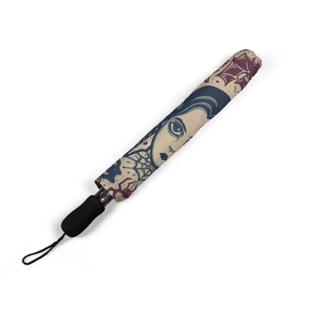 The Wednesday Addams umbrella collapsed small enough for a backpack pocket.