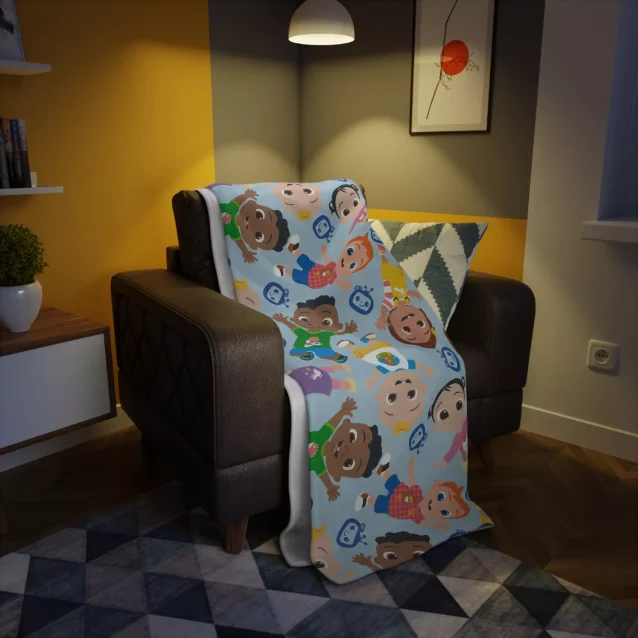 A blue Cocomelon plush blanket featuring all the characters, perfect for snuggles and bedtime stories.