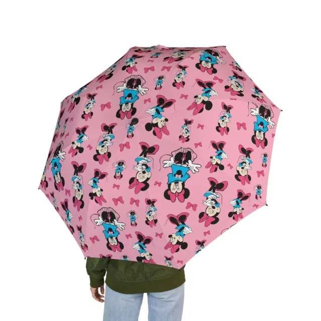 The soft foam handle of the Minnie Mouse umbrella, held in one hand.