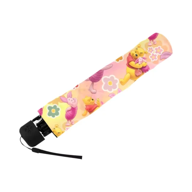 The soft foam handle of the Pooh Bear umbrella, held in one hand.