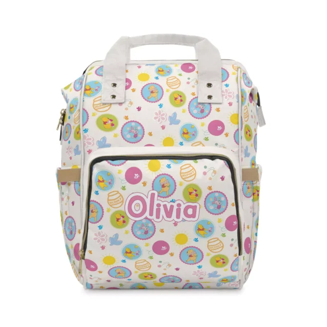 White pooh bear diaper bag with pastel hunny-pot badges of baby Pooh and Piglet.
