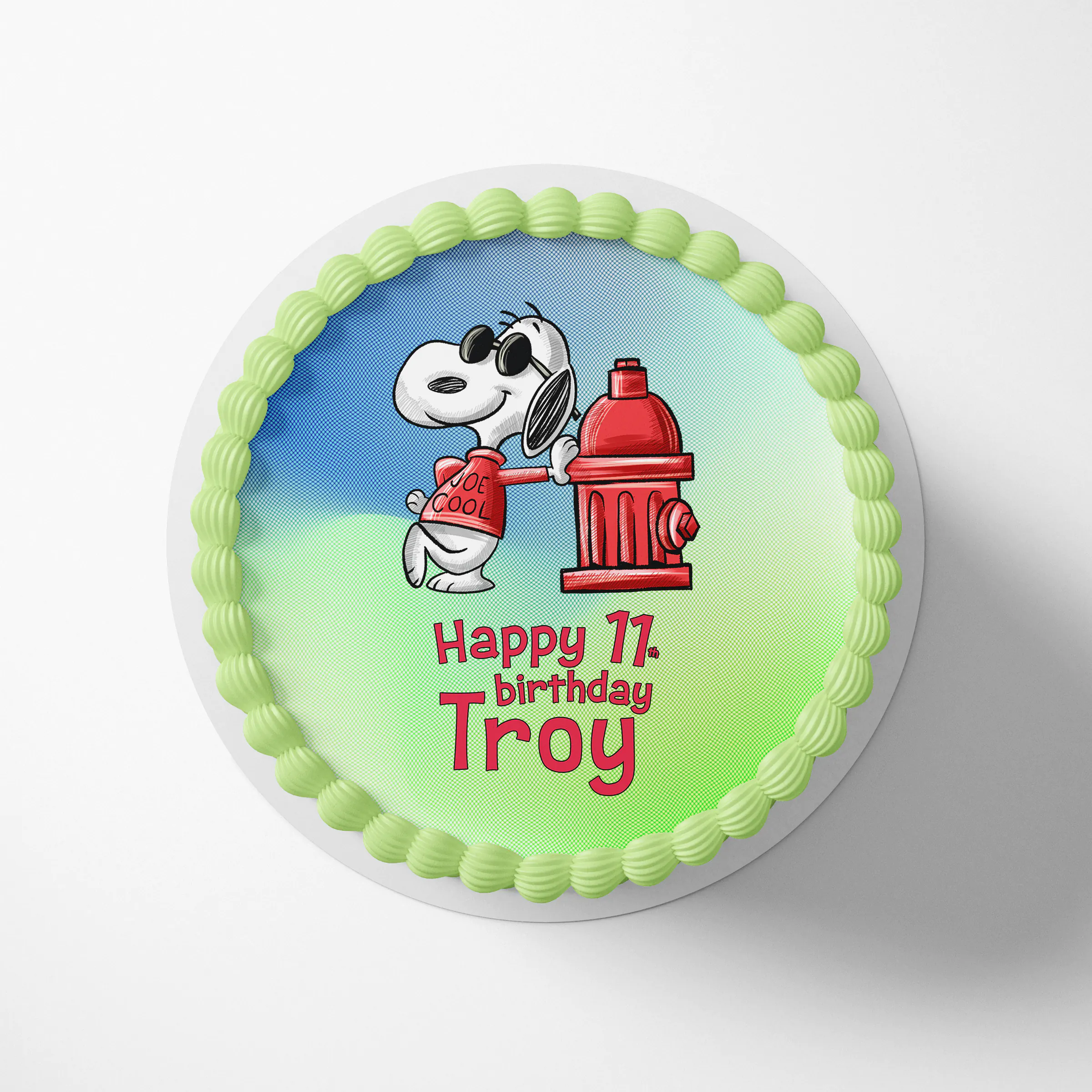 Personalized Joe Cool Snoopy cake topper on a round birthday cake