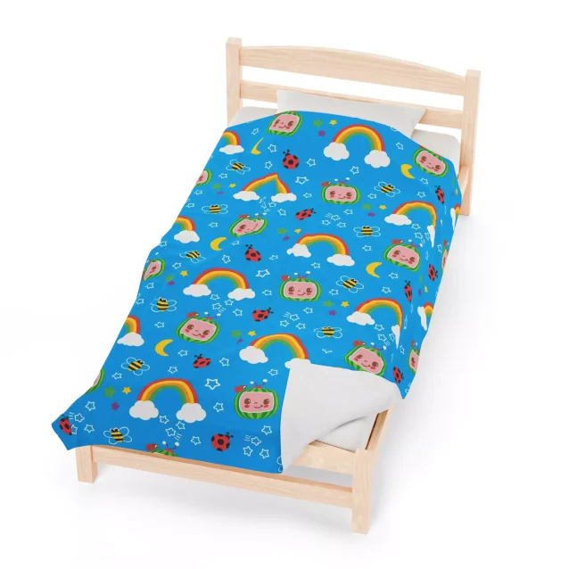 This luxuriously soft blue fleece throw blanket is adorned with playful Cocomelon characters, making it a must-have for any child's room.
