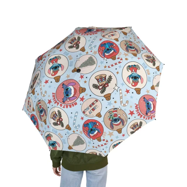Sheltering under the Lilo & Stitch Christmas umbrella on a wet day.
