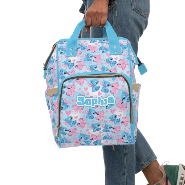 A white diaper bag with playful pink and blue accents, inspired by the Disney movie Lilo & Stitch.