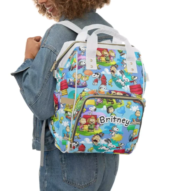 Snoopy Peanuts diaper bag worn as a backpack for hands-free carrying.