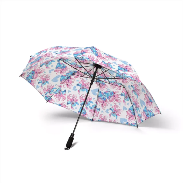 The Stitch umbrella held against a grey, rainy sky.