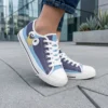 A young child playing outdoors wearing custom Bluey shoes and bright blue kids canvas sneakers on a garden walkway