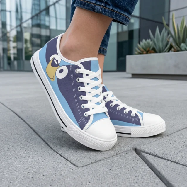 A young child playing outdoors wearing custom Bluey shoes and bright blue kids canvas sneakers on a garden walkway