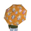 The Bluey Halloween umbrella tucked under an arm, folded away.