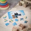 Father and child enjoying family game night with their Bluey dad puzzle.