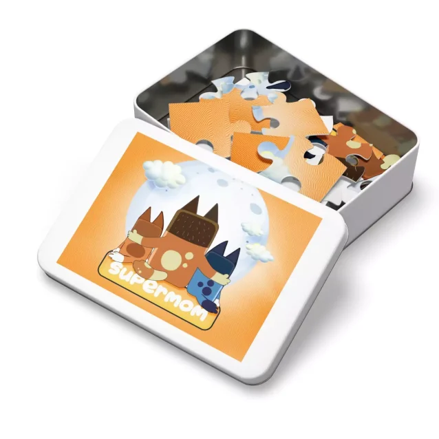 A mother smiling while working on the 1000-piece Bluey puzzle for adults.